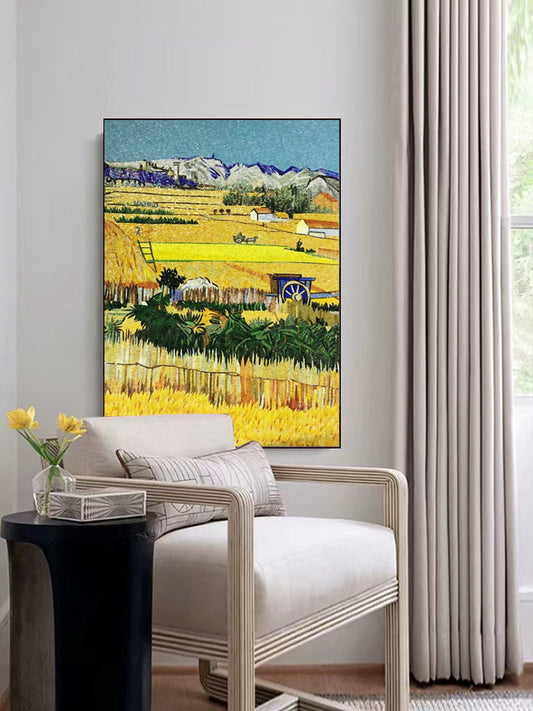 Vibrant landscape glass mosaic artwork featuring golden wheat fields and purple mountains displayed in contemporary living room with modern chair